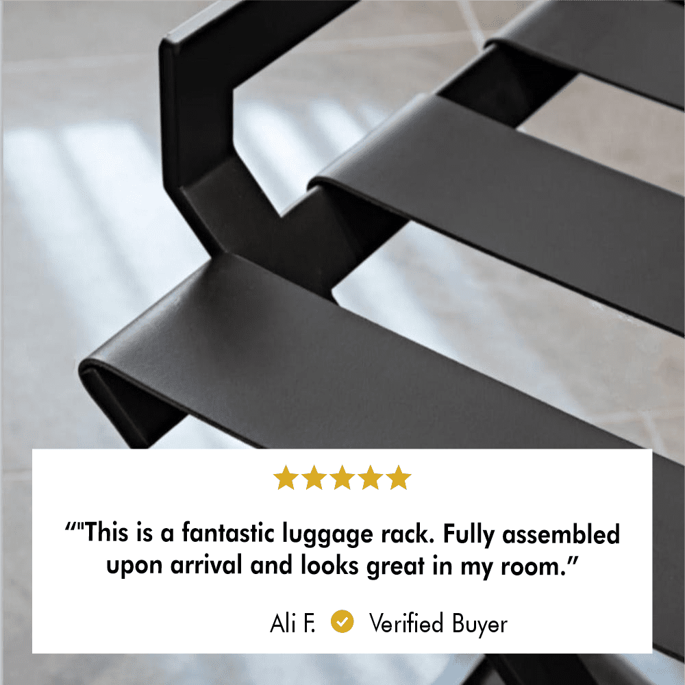 A close-up of the black luggage rack’s leather straps, emphasizing their smooth texture and durable quality, with sunlight streaming through nearby windows