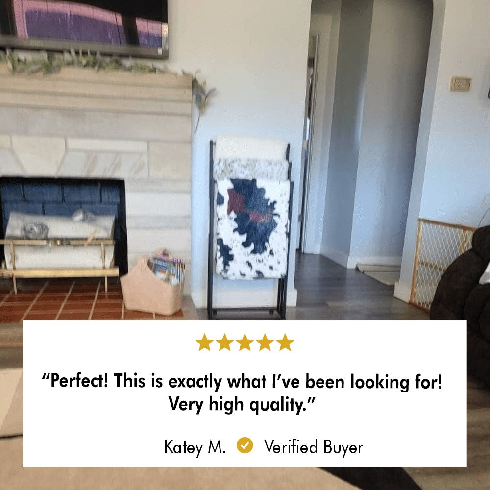 A verified customer review of a free-standing towel rack placed next to a cozy fireplace, with a five-star rating and positive feedback.
