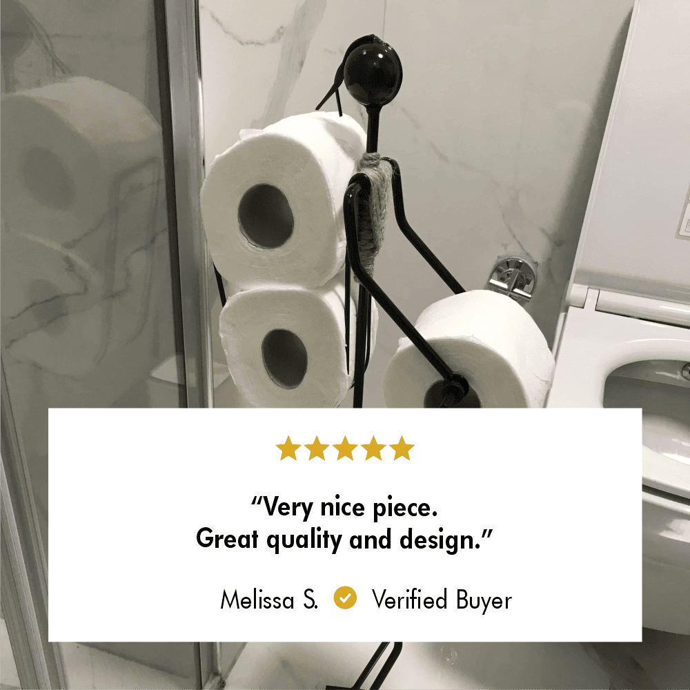 Minimalist toilet paper holder in a bathroom, holding three rolls of toilet paper. Five-star review from verified buyer Melissa S. stating 'Very nice piece. Great quality and design.