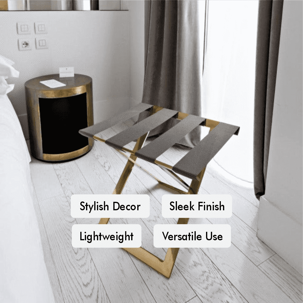 A gold metal luggage rack placed in a modern bedroom near a window, highlighting its versatile use, lightweight design, and sleek finish.
