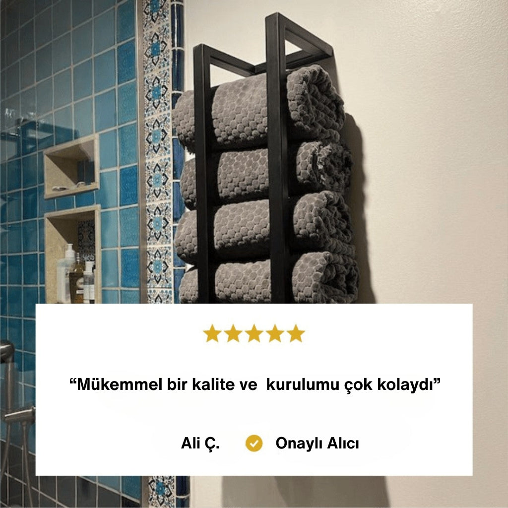 Mavi fayanslı banyo duvarına monte edilmiş siyah metal havlu rafında gri havlular düzenli şekilde yerleştirilmiştir. Alt bölümde müşteri yorumu yer almaktadır: “Mükemmel bir kalite ve kurulumu çok kolaydı.” Yorum “Ali Ç. - Onaylı Alıcı” olarak belirtilmiştir.